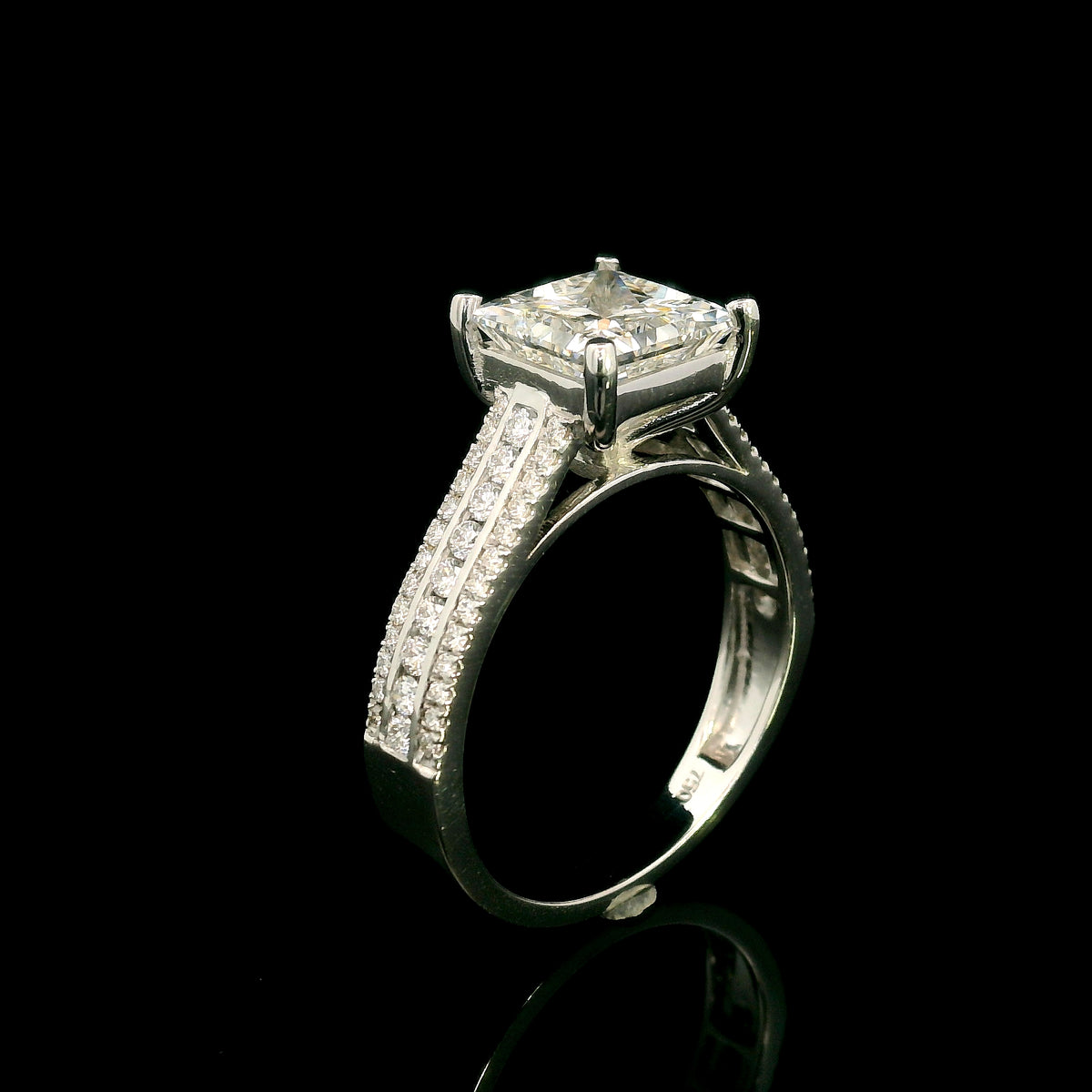 Natural princess cut diamond engagement ring in 18K white gold featuring a 2.19 carat IGI-certified F colour VS1 clarity centre diamond and 0.42 carat of round diamonds along the pavé-set band.