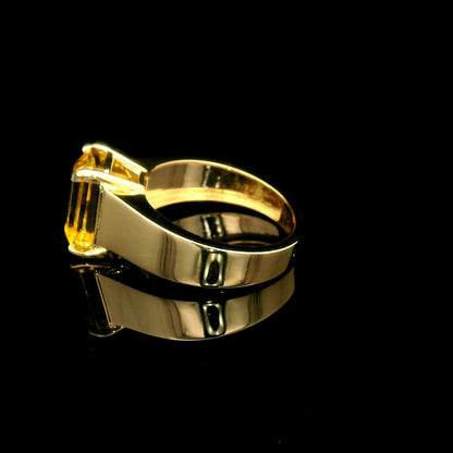 Men's yellow beryl ring in 18K yellow gold featuring a rectangular emerald-cut gemstone in a four-prong setting and a wide gold band.