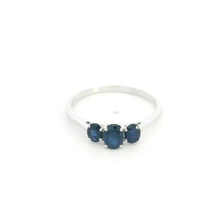 18K white gold ring featuring three oval blue sapphires, with a larger centre gemstone and two smaller side stones on a slim polished band.