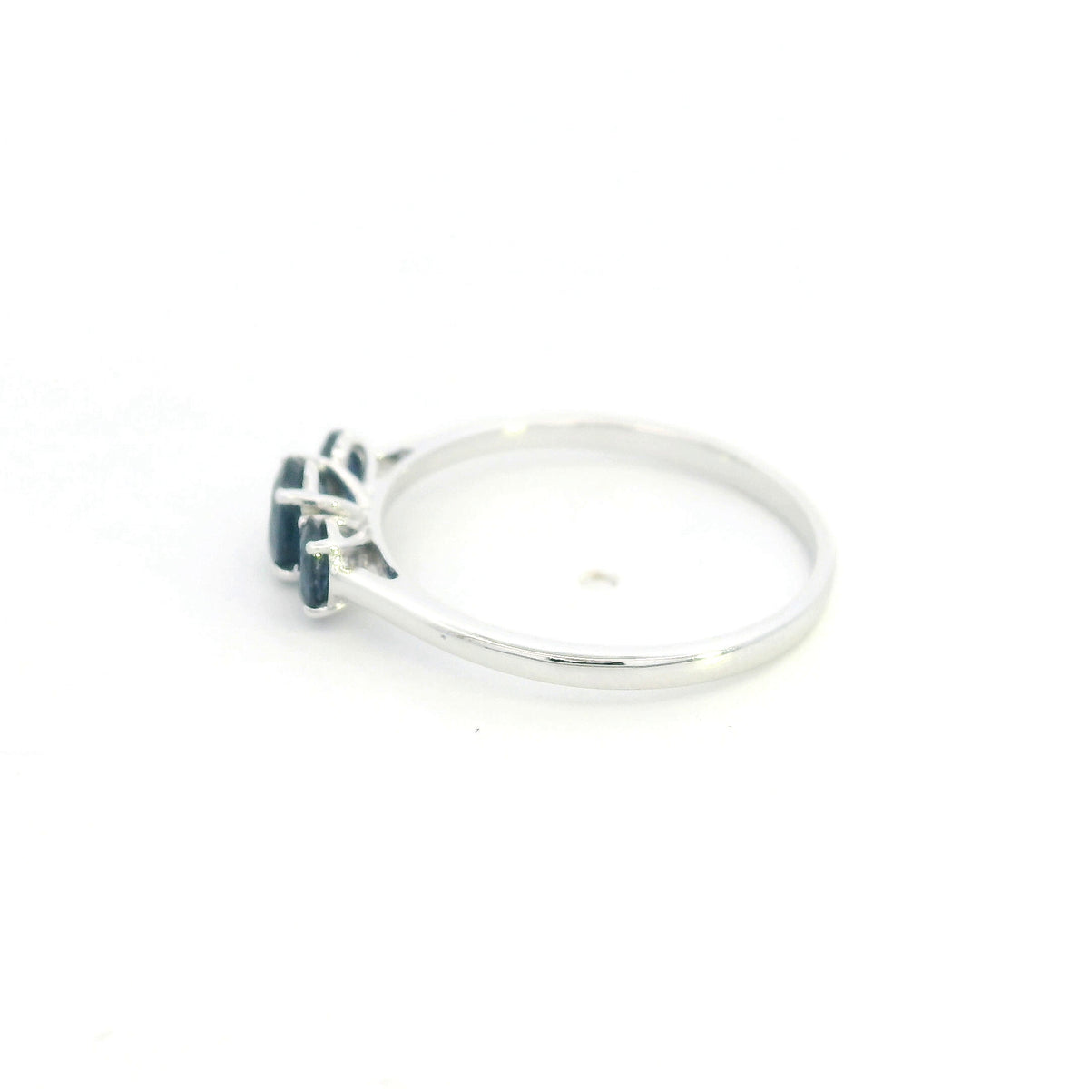 18K white gold ring featuring three oval blue sapphires, with a larger centre gemstone and two smaller side stones on a slim polished band.
