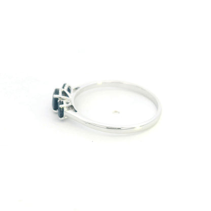 18K white gold ring featuring three oval blue sapphires, with a larger centre gemstone and two smaller side stones on a slim polished band.