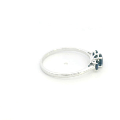 18K white gold ring featuring three oval blue sapphires, with a larger centre gemstone and two smaller side stones on a slim polished band.