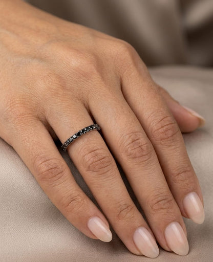 18K white gold half eternity ring featuring a single row of round black diamonds set across the front of a slim, polished band.