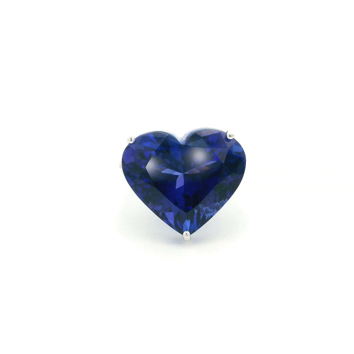 Heart shaped tanzanite ring in 18K white gold featuring a 25.18 carat blue-violet gemstone and diamond-set shoulders.