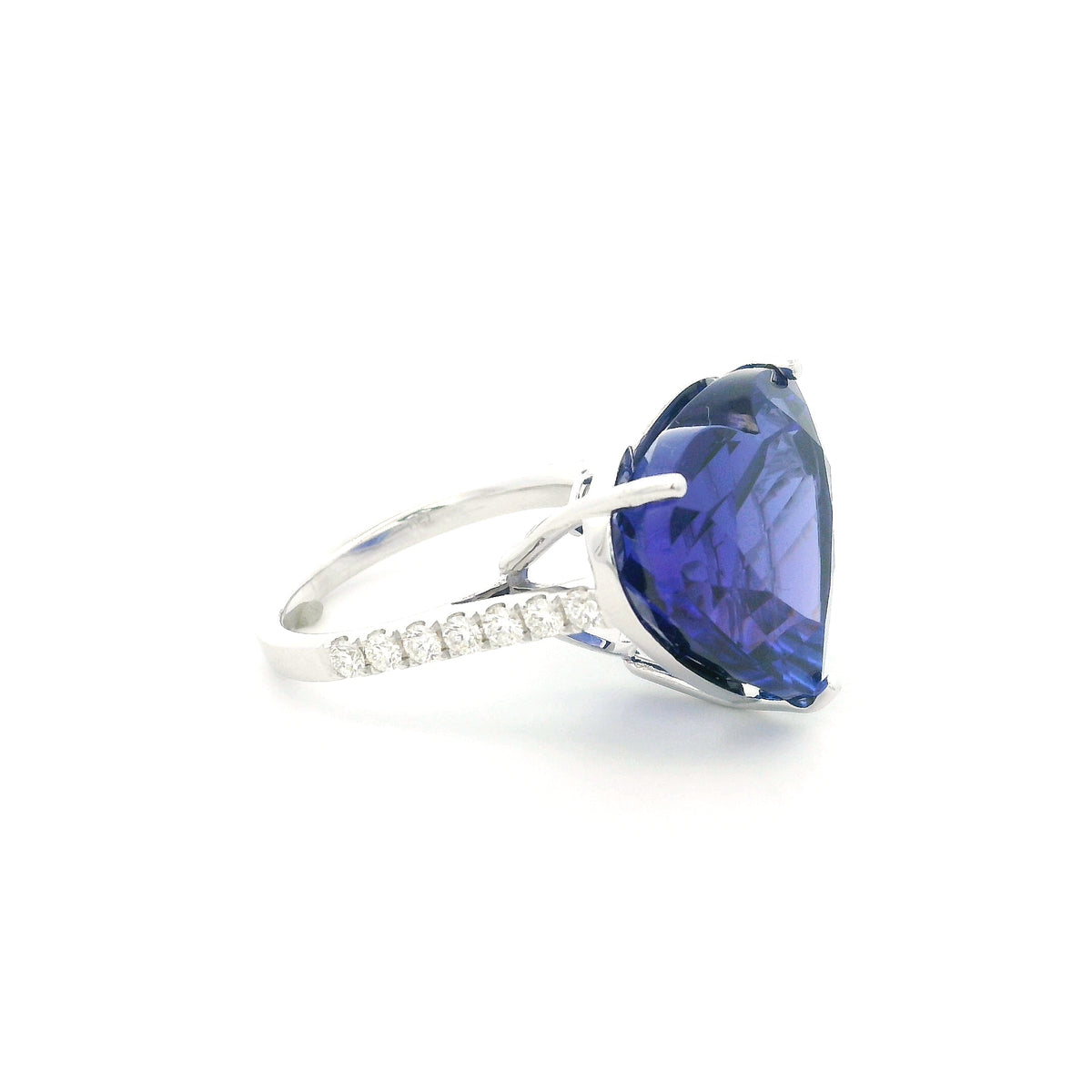 Heart shaped tanzanite ring in 18K white gold featuring a 25.18 carat blue-violet gemstone and diamond-set shoulders.
