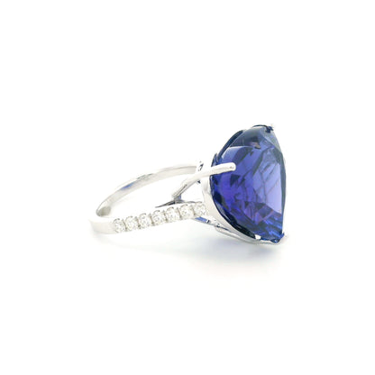 Heart shaped tanzanite ring in 18K white gold featuring a 25.18 carat blue-violet gemstone and diamond-set shoulders.