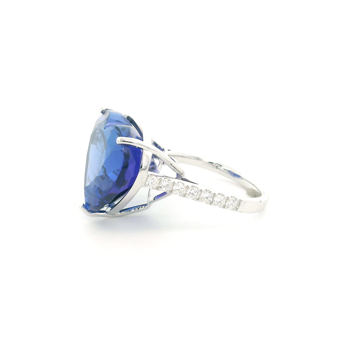 Heart shaped tanzanite ring in 18K white gold featuring a 25.18 carat blue-violet gemstone and diamond-set shoulders.