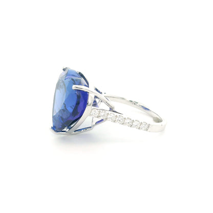 Heart shaped tanzanite ring in 18K white gold featuring a 25.18 carat blue-violet gemstone and diamond-set shoulders.