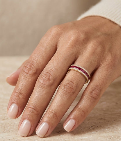 18K yellow gold band ring with a row of square-cut red rubies bordered above and below by small round diamonds.