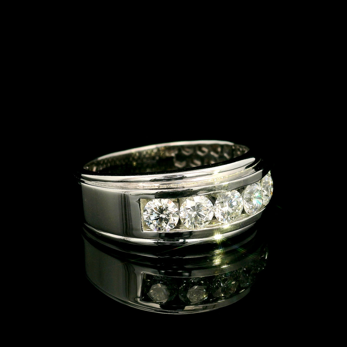 Men's 18K white gold band with five round diamonds in a channel-style setting framed by broad polished gold edges.