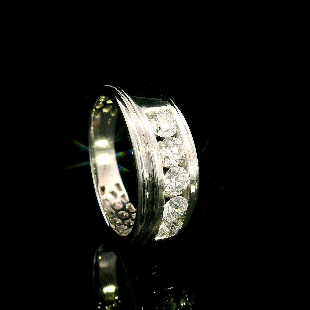 Men's 18K white gold band with five round diamonds in a channel-style setting framed by broad polished gold edges.