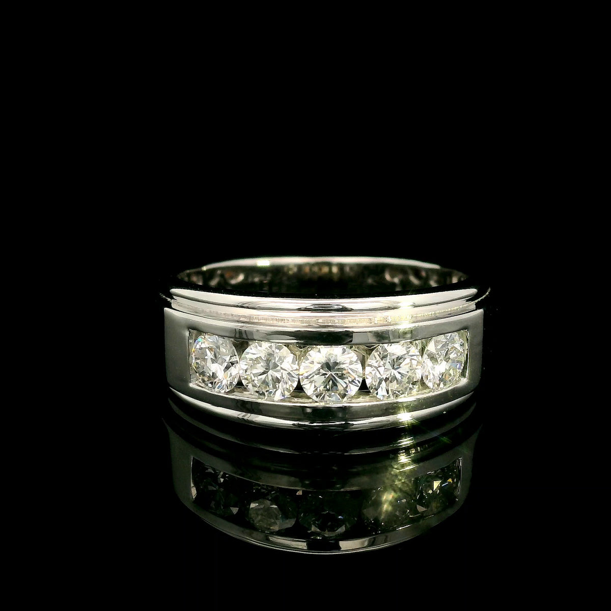 Men's 18K white gold band with five round diamonds in a channel-style setting framed by broad polished gold edges.