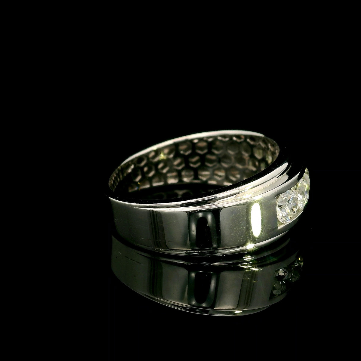 Men's 18K white gold band with five round diamonds in a channel-style setting framed by broad polished gold edges.