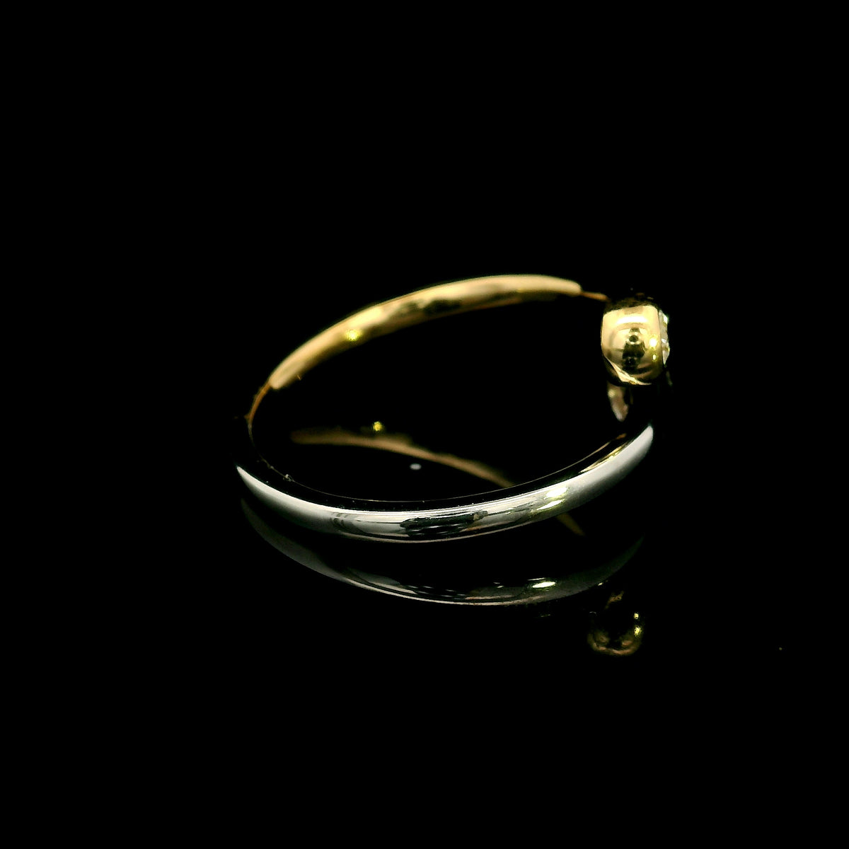 18K white and yellow gold bypass ring with two round diamonds in bezel settings at the ends of curved, overlapping bands.