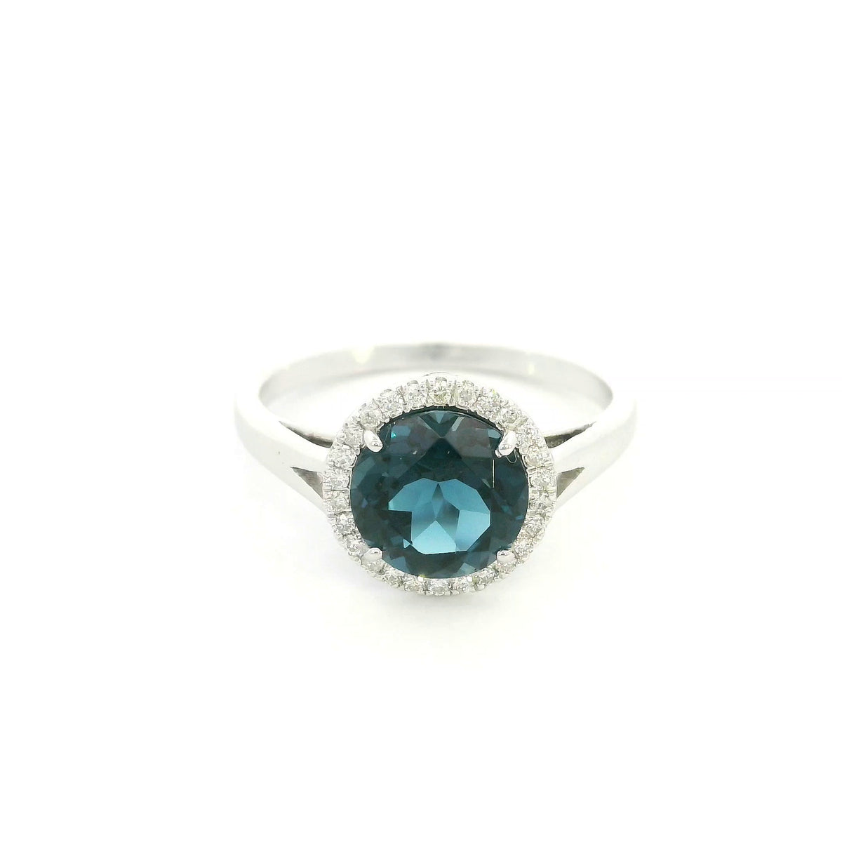 18K white gold ring with a deep blue London blue topaz surrounded by round diamonds and a split-shoulder band.