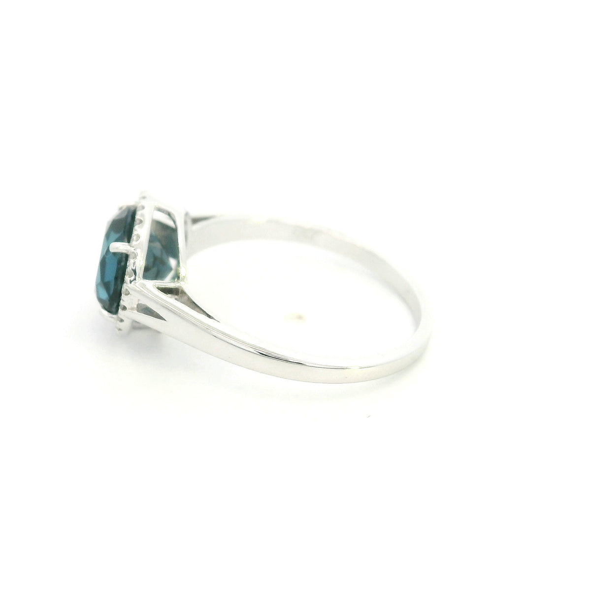 18K white gold ring with a deep blue London blue topaz surrounded by round diamonds and a split-shoulder band.