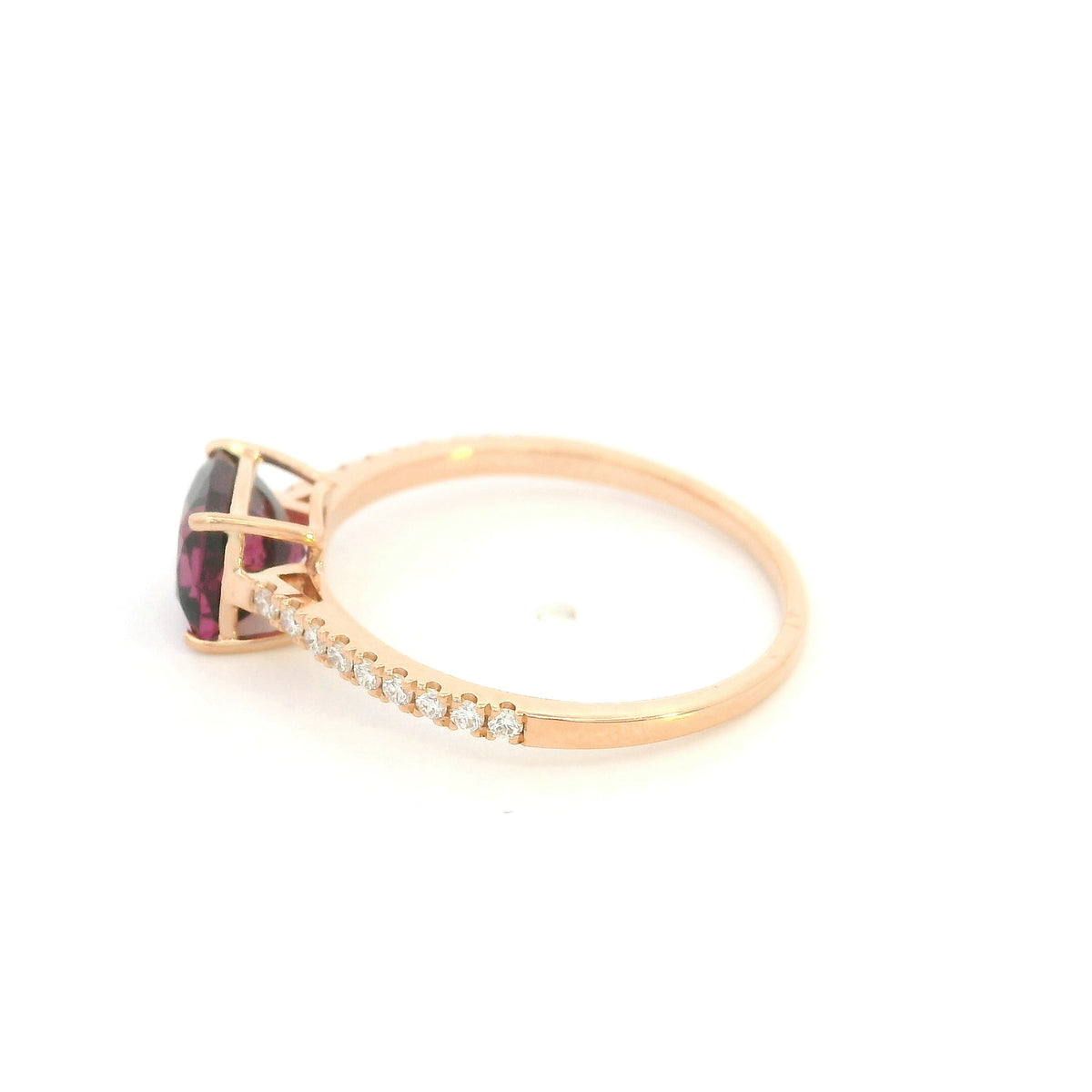 18K rose gold ring with a cushion-cut raspberry-pink rhodolite garnet and pavé diamond shoulders.