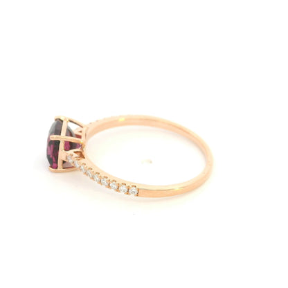 18K rose gold ring with a cushion-cut raspberry-pink rhodolite garnet and pavé diamond shoulders.