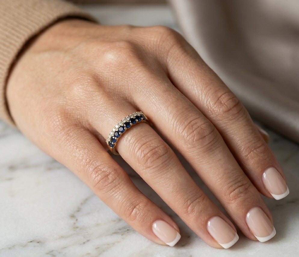 18K yellow gold band ring with two adjacent rows of round blue sapphires and white diamonds across the front.