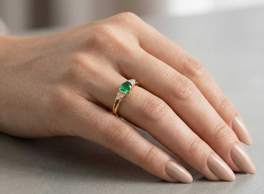 18K yellow gold emerald and diamond ring with 0.32 carat emerald and diamond accents.