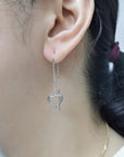 Needle And Thread Earrings With Heart Charms In 18k White Gold.