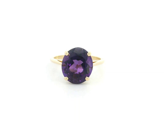 Oval amethyst solitaire ring in 18K yellow gold featuring a 4.39 carat natural amethyst by Emirates Diamonds.