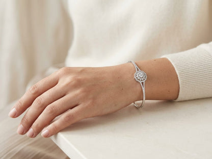 18K white gold diamond halo bangle with round brilliant centre and split diamond-set shoulders
