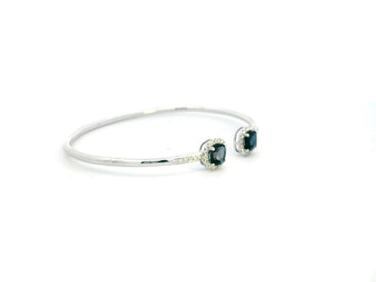 18K gold bangle with London Blue Topaz and diamond halo in an open cuff design.