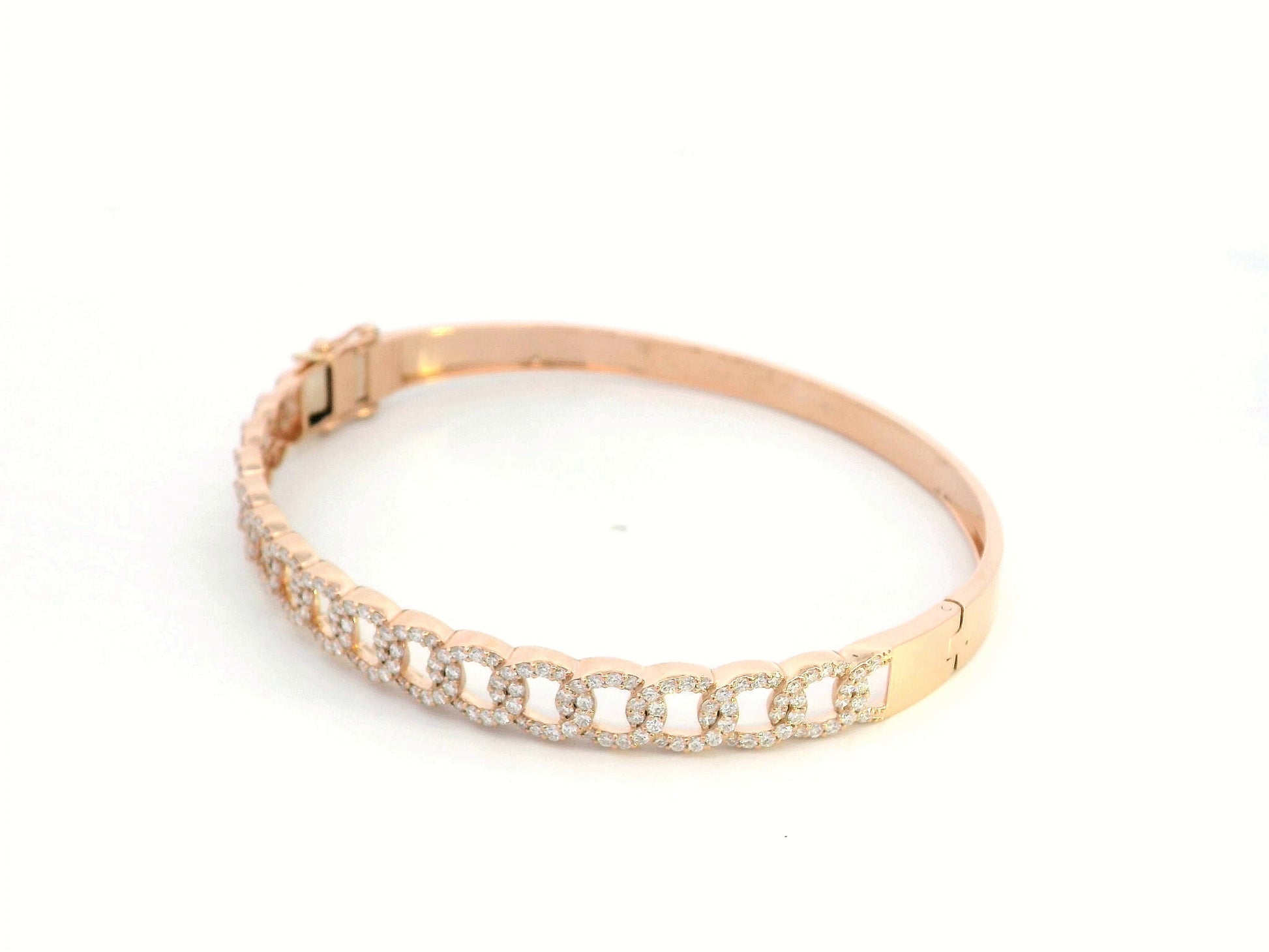 Unisex Cuban link diamond bangle in 18K rose gold with 1.26 carats of round-cut diamonds.