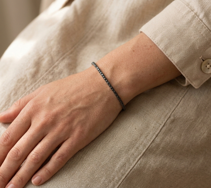 18K rose gold black diamond tennis bangle with modern slim luxury design.