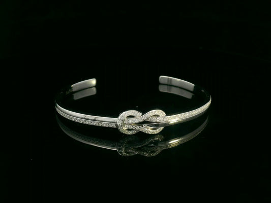 18K white gold diamond knot bangle with pavé-set natural diamonds by Emirates Diamonds