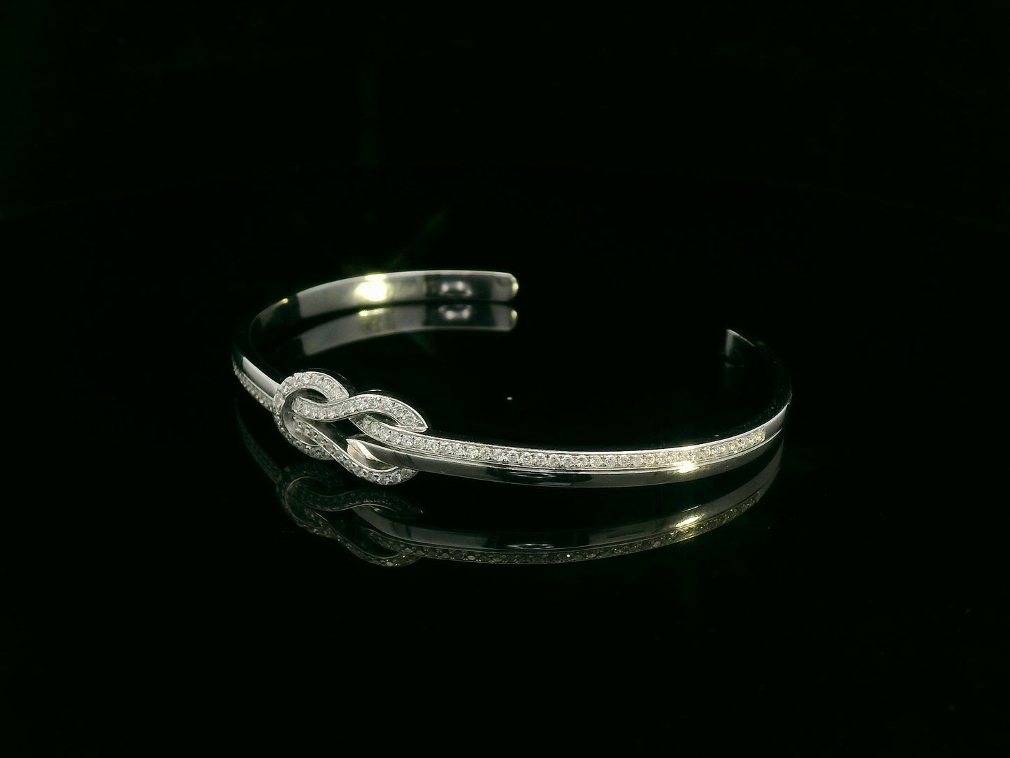 18K white gold diamond knot bangle with pavé-set natural diamonds by Emirates Diamonds