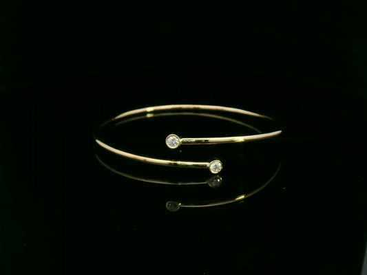 Diamond open cuff bangle bracelet in 18K yellow gold with bezel set diamonds by Emirates Diamonds