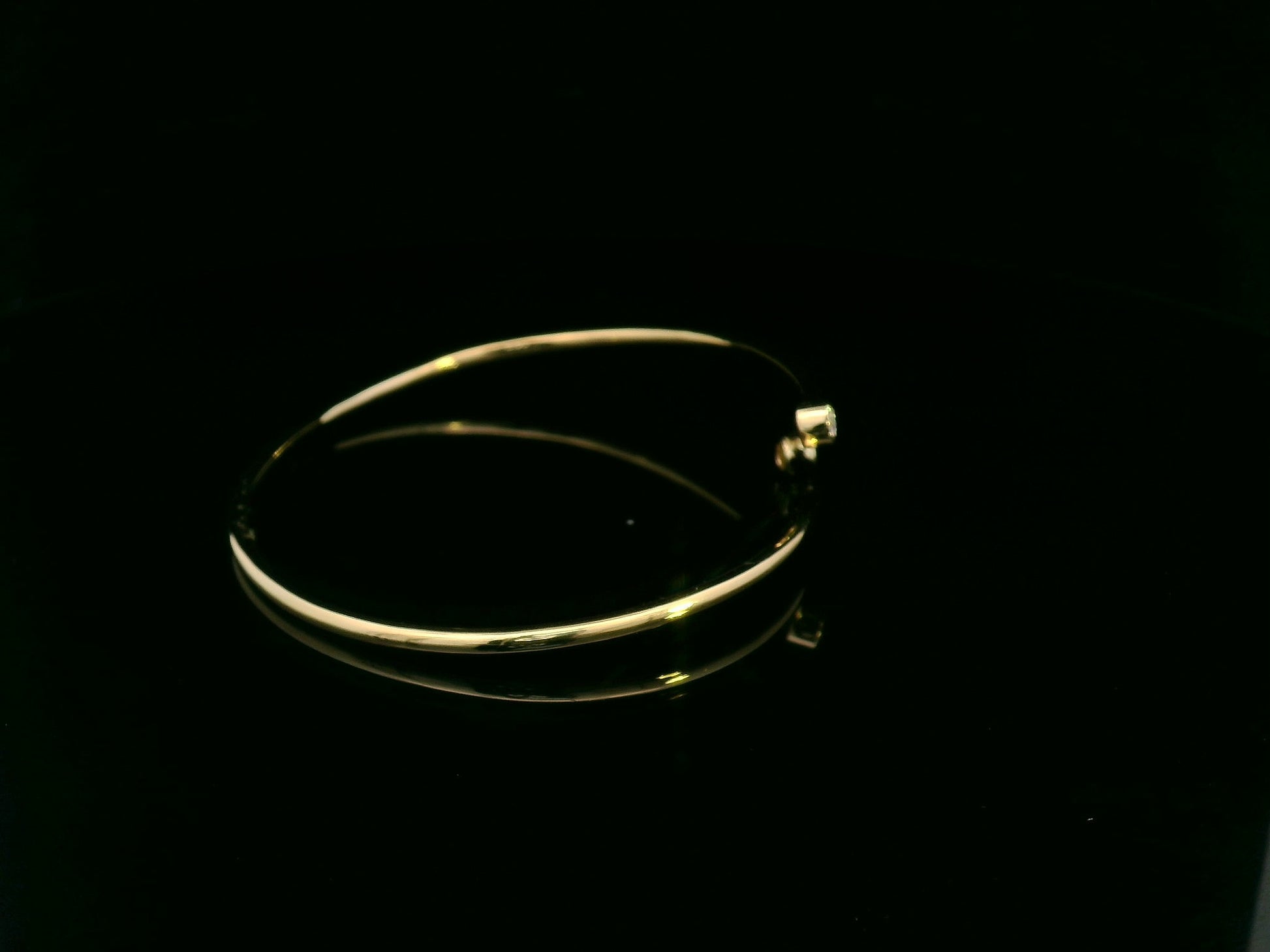 Diamond open cuff bangle bracelet in 18K yellow gold with bezel set diamonds by Emirates Diamonds