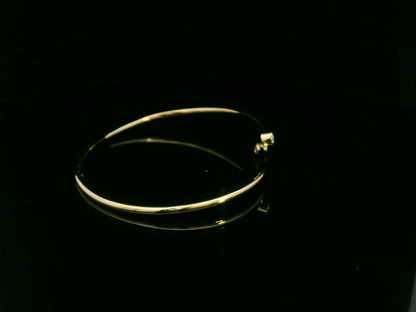 Diamond open cuff bangle bracelet in 18K yellow gold with bezel set diamonds by Emirates Diamonds