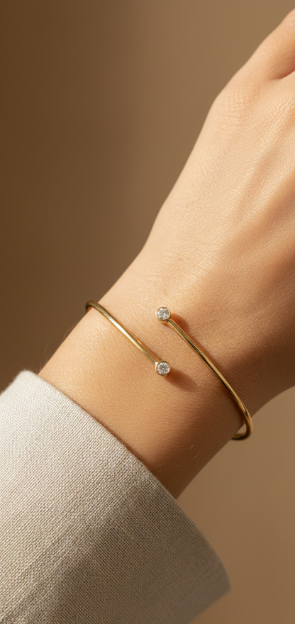 Diamond open cuff bangle bracelet in 18K yellow gold with bezel set diamonds by Emirates Diamonds