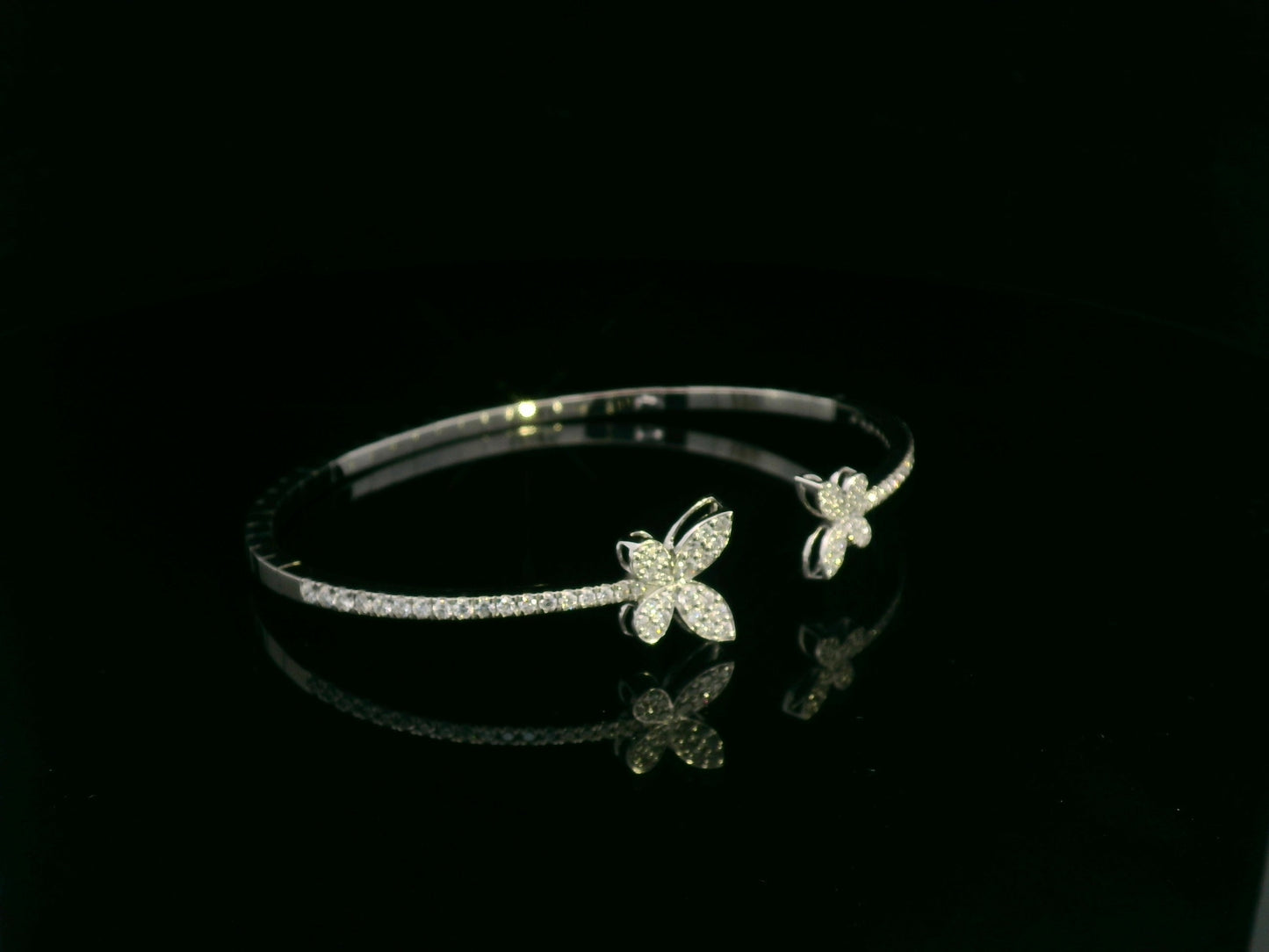 0.85 carat diamond butterfly bangle in 18K white gold by Emirates Diamonds with pavé diamond band.