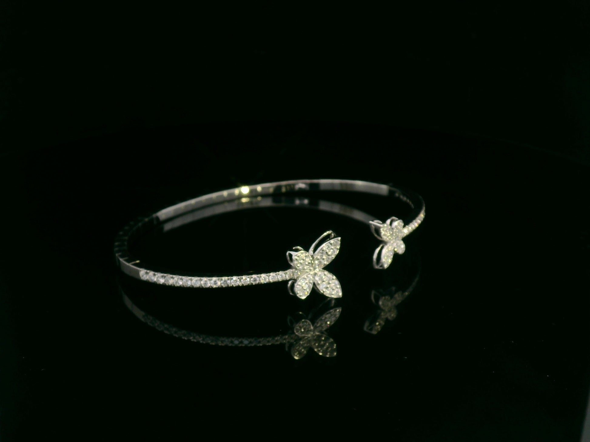 0.85 carat diamond butterfly bangle in 18K white gold by Emirates Diamonds with pavé diamond band.