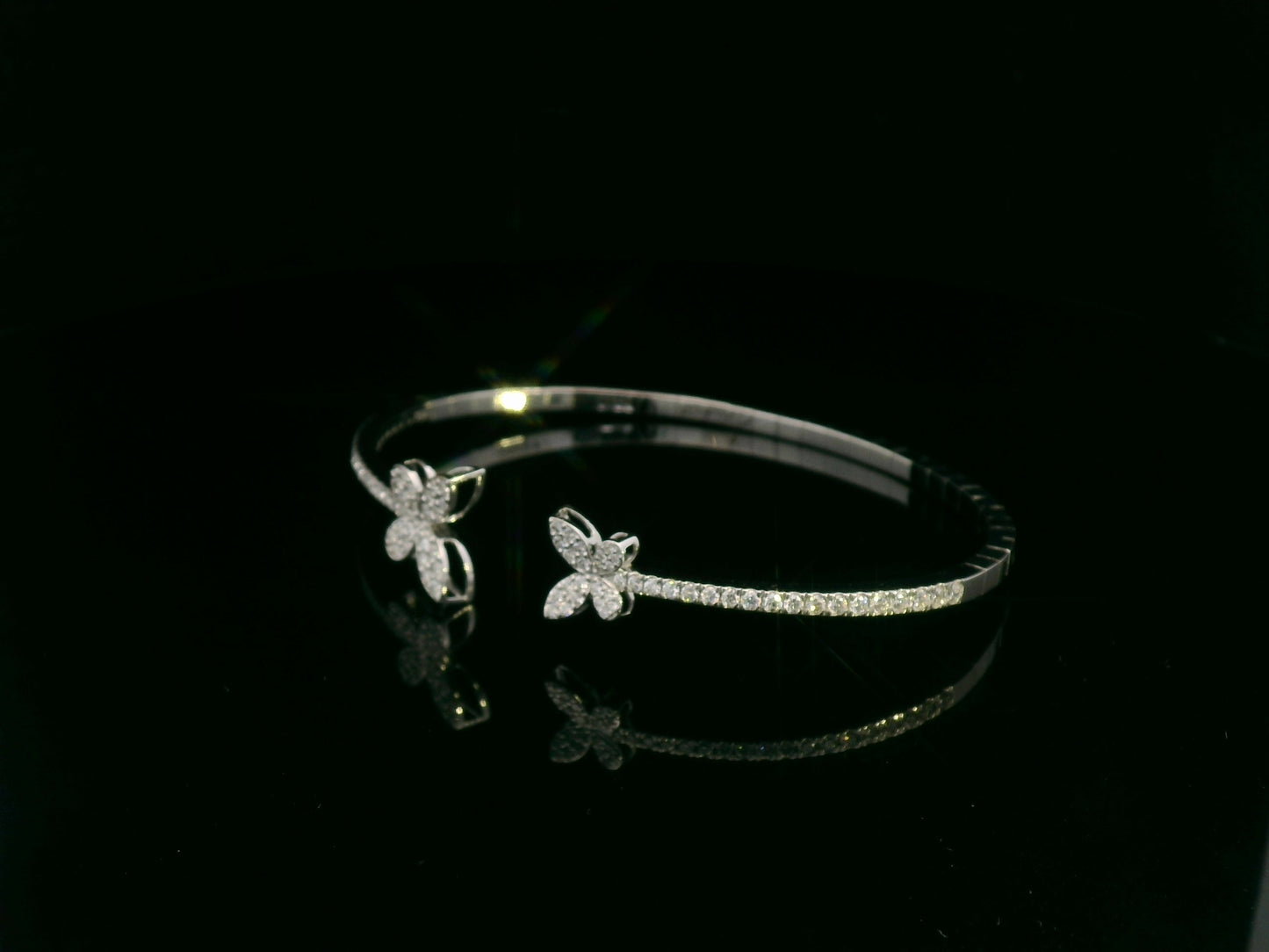 0.85 carat diamond butterfly bangle in 18K white gold by Emirates Diamonds with pavé diamond band.