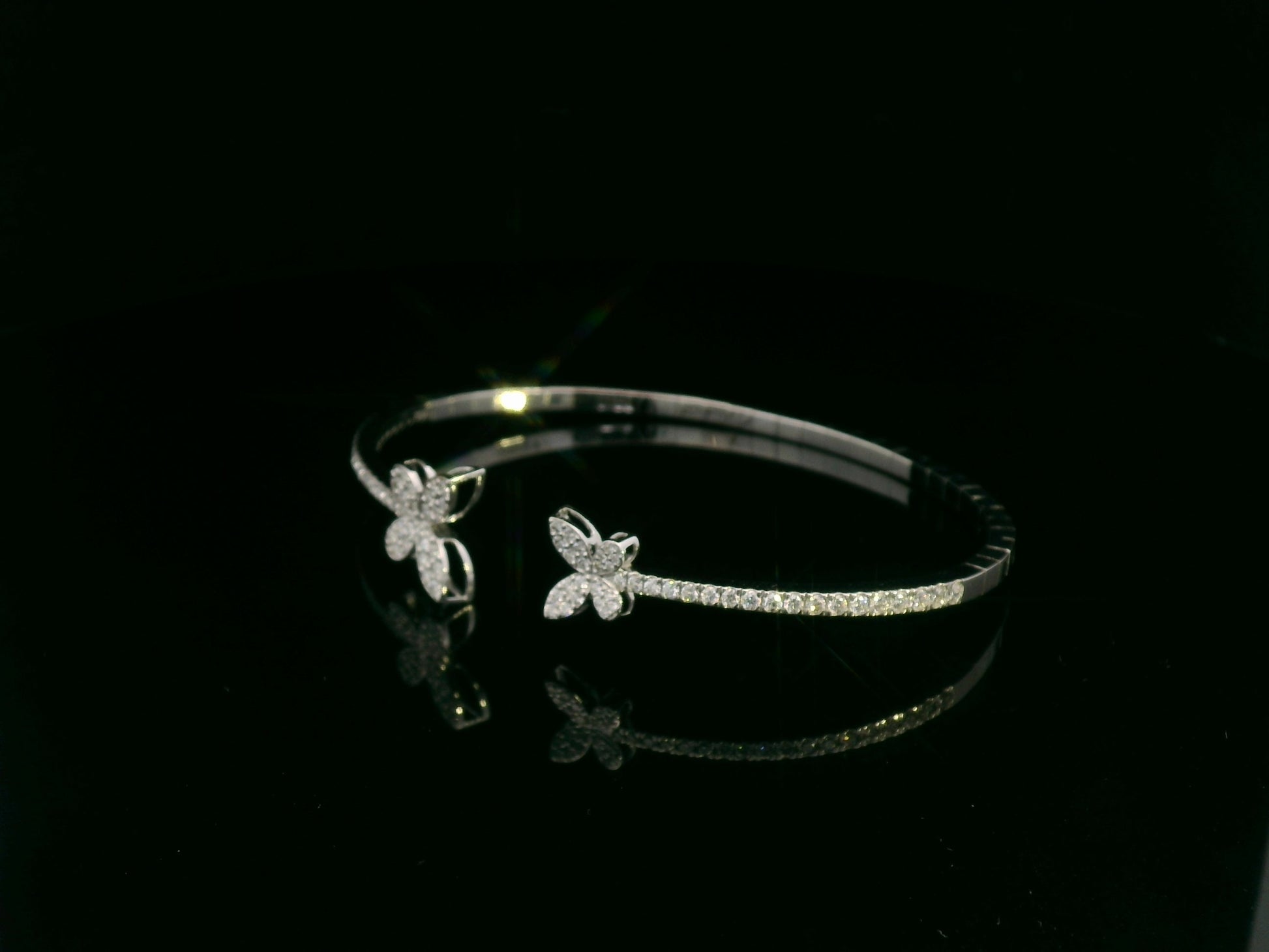 0.85 carat diamond butterfly bangle in 18K white gold by Emirates Diamonds with pavé diamond band.