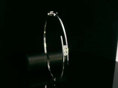 0.25 carat diamond bypass bangle in 18K white gold by Emirates Diamonds featuring floating round brilliant diamonds.