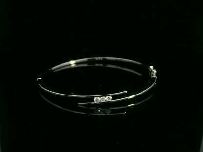 0.25 carat diamond bypass bangle in 18K white gold by Emirates Diamonds featuring floating round brilliant diamonds.