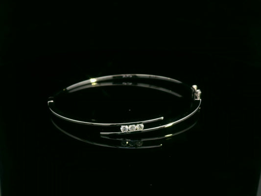 0.25 carat diamond bypass bangle in 18K white gold by Emirates Diamonds featuring floating round brilliant diamonds.
