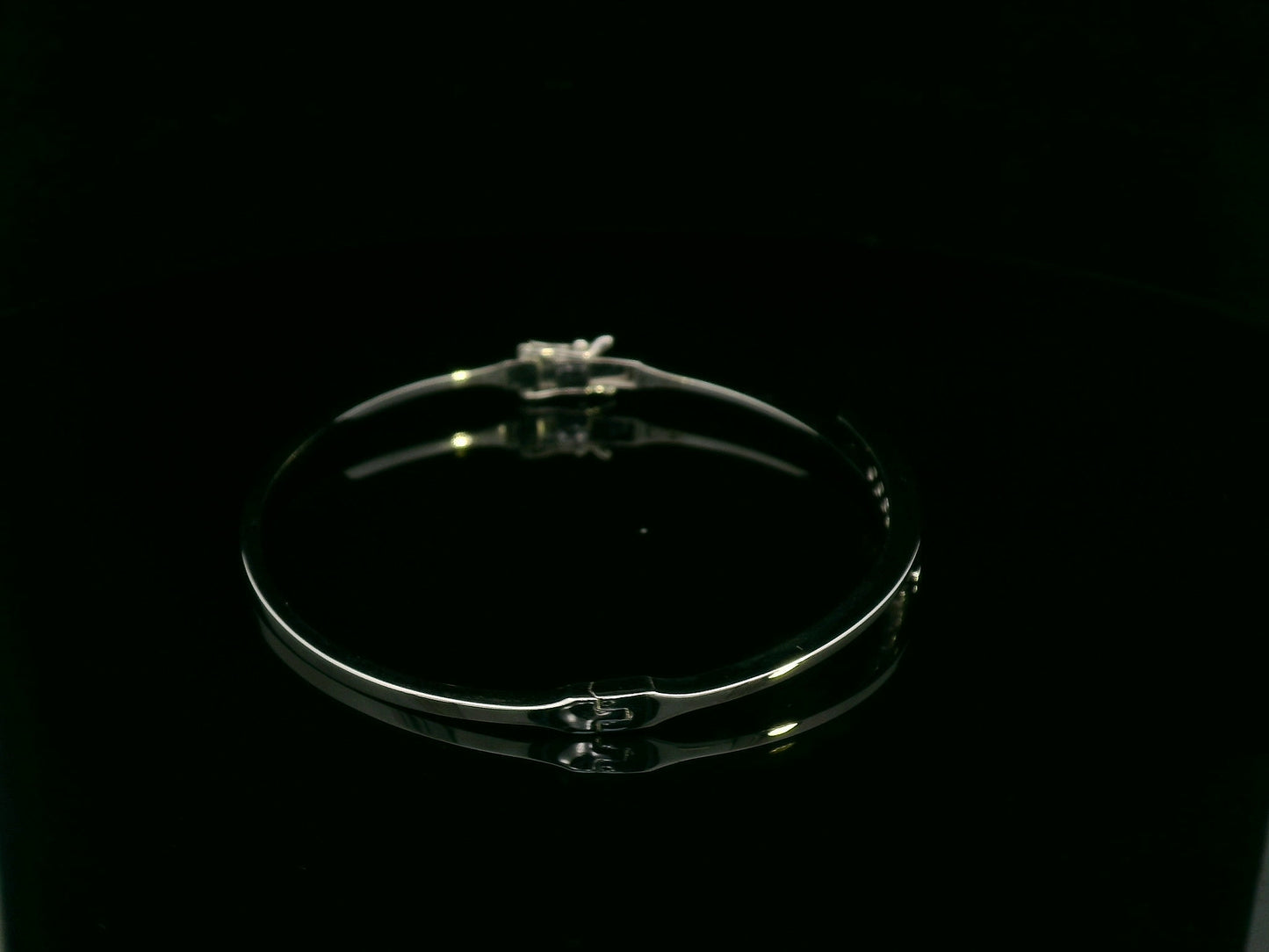 0.25 carat diamond bypass bangle in 18K white gold by Emirates Diamonds featuring floating round brilliant diamonds.
