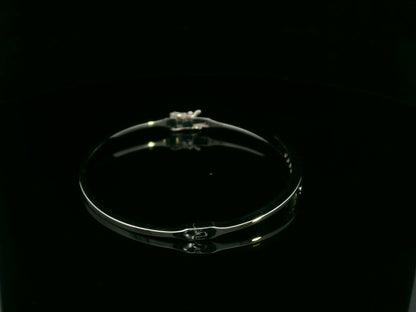 0.25 carat diamond bypass bangle in 18K white gold by Emirates Diamonds featuring floating round brilliant diamonds.