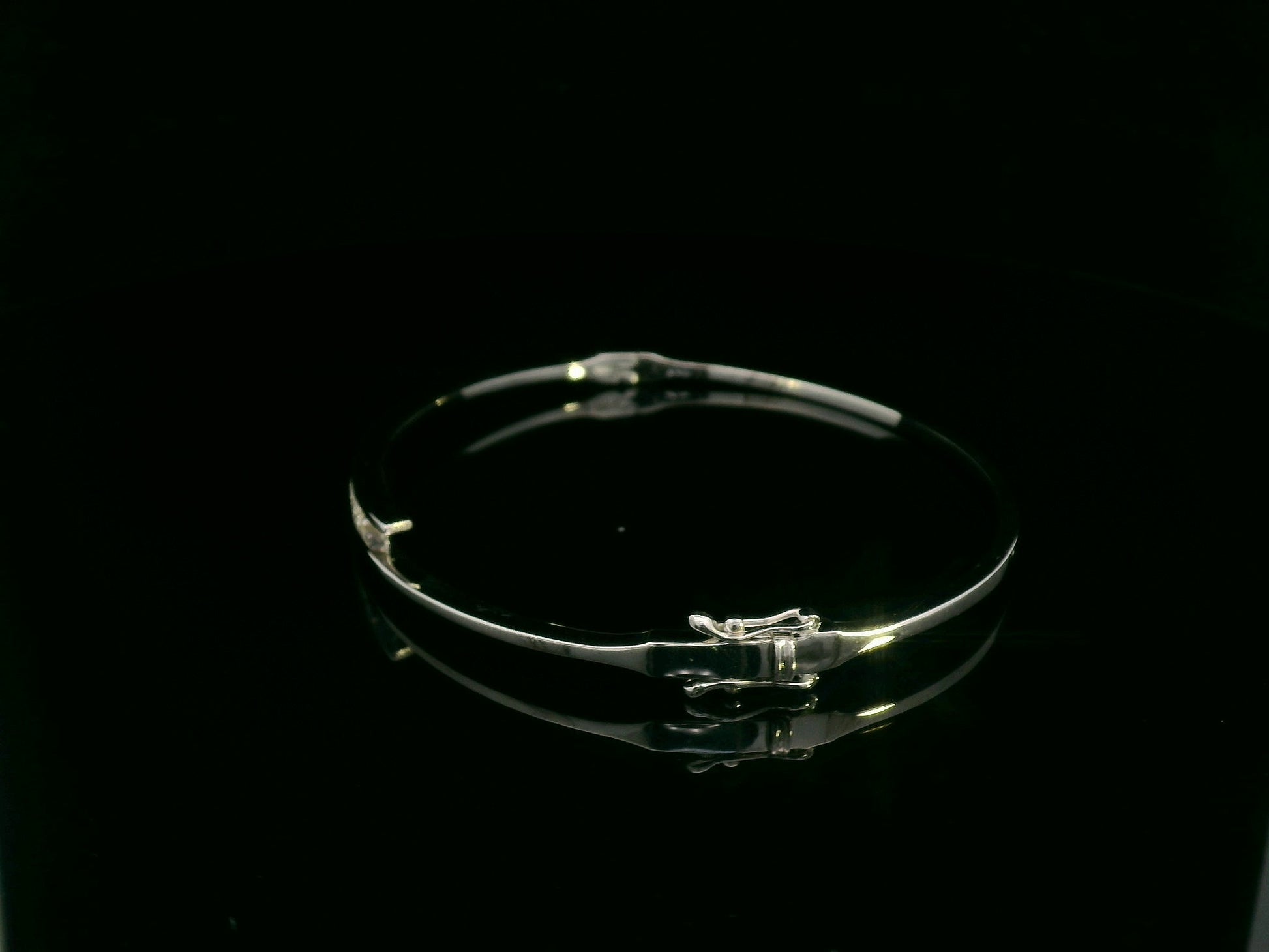 0.25 carat diamond bypass bangle in 18K white gold by Emirates Diamonds featuring floating round brilliant diamonds.