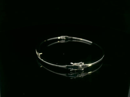 0.25 carat diamond bypass bangle in 18K white gold by Emirates Diamonds featuring floating round brilliant diamonds.