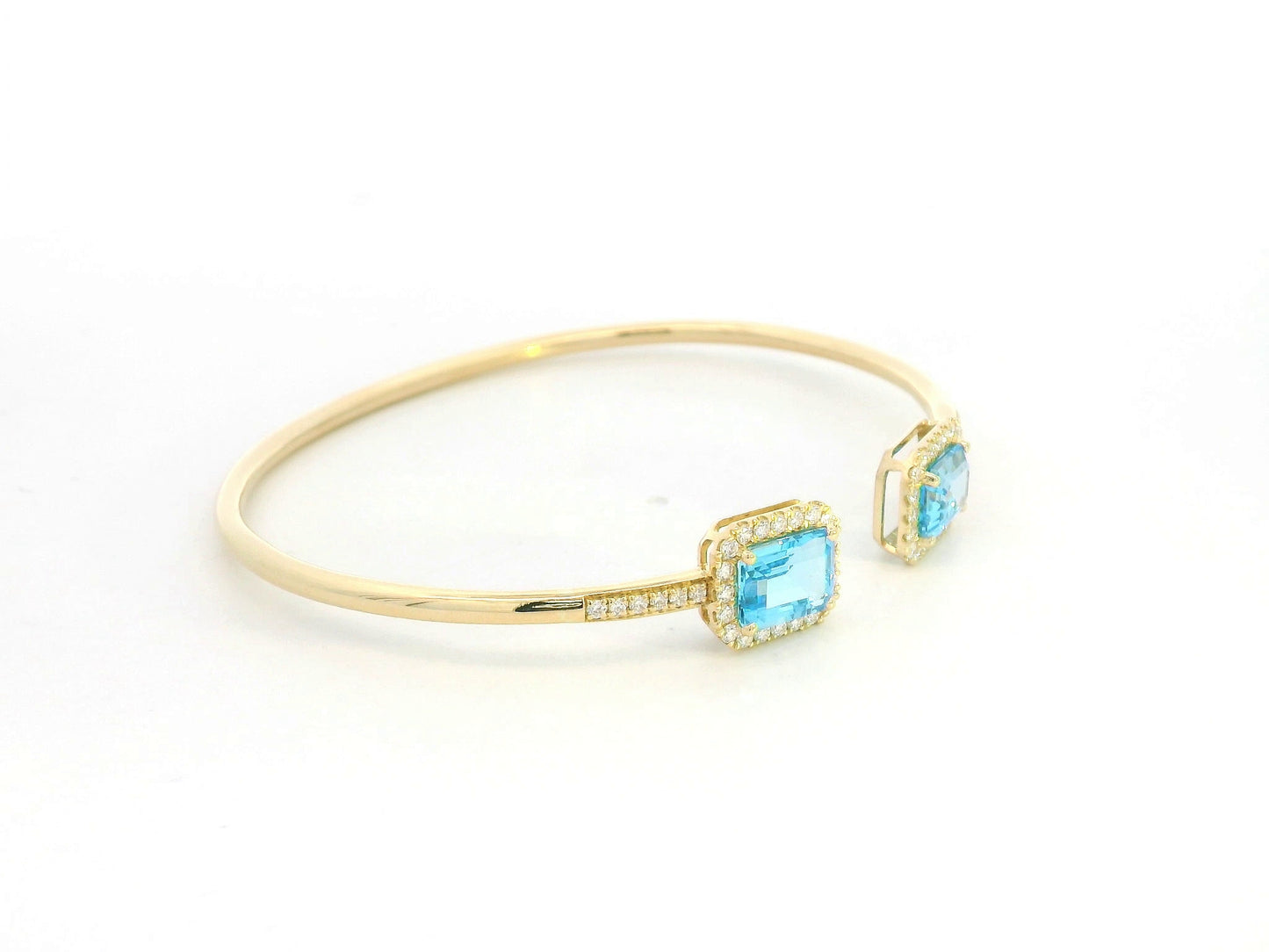 Blue topaz and diamond open cuff bangle bracelet in 18K yellow gold by Emirates Diamonds