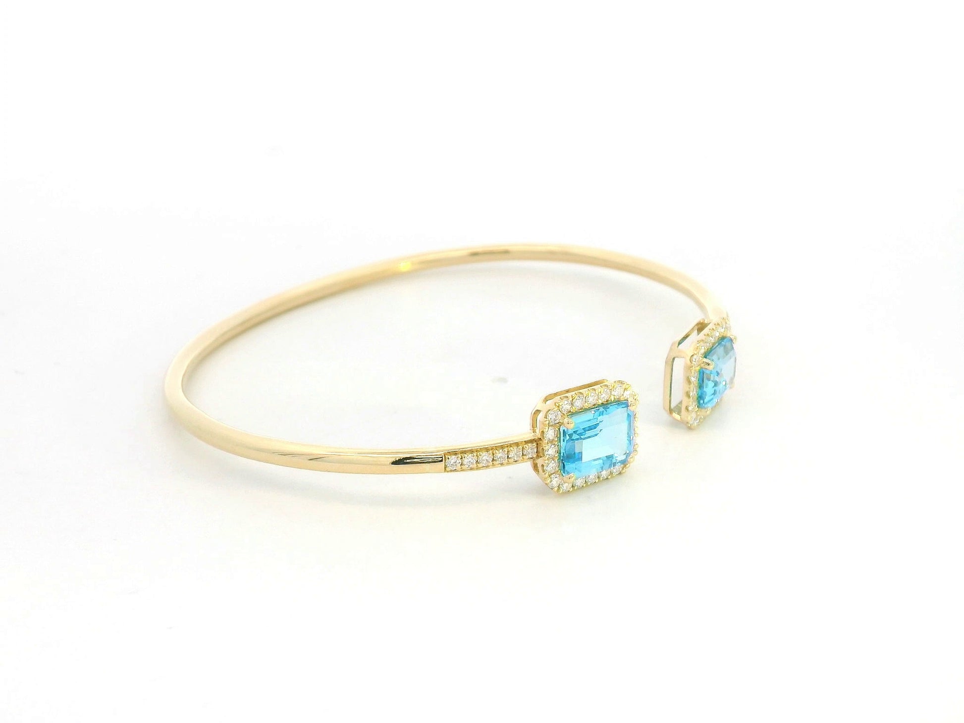Blue topaz and diamond open cuff bangle bracelet in 18K yellow gold by Emirates Diamonds