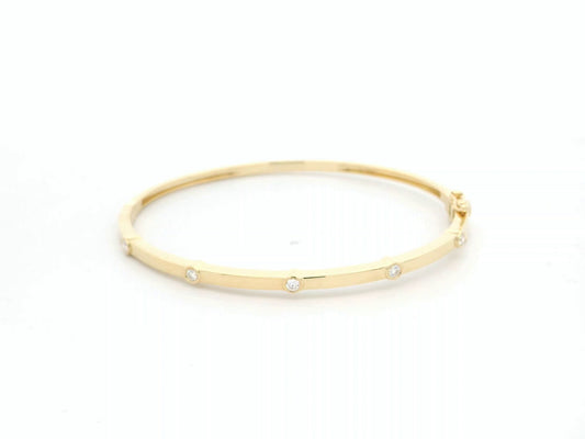 Minimal diamond bangle bracelet in 18K yellow gold with bezel-set natural diamonds